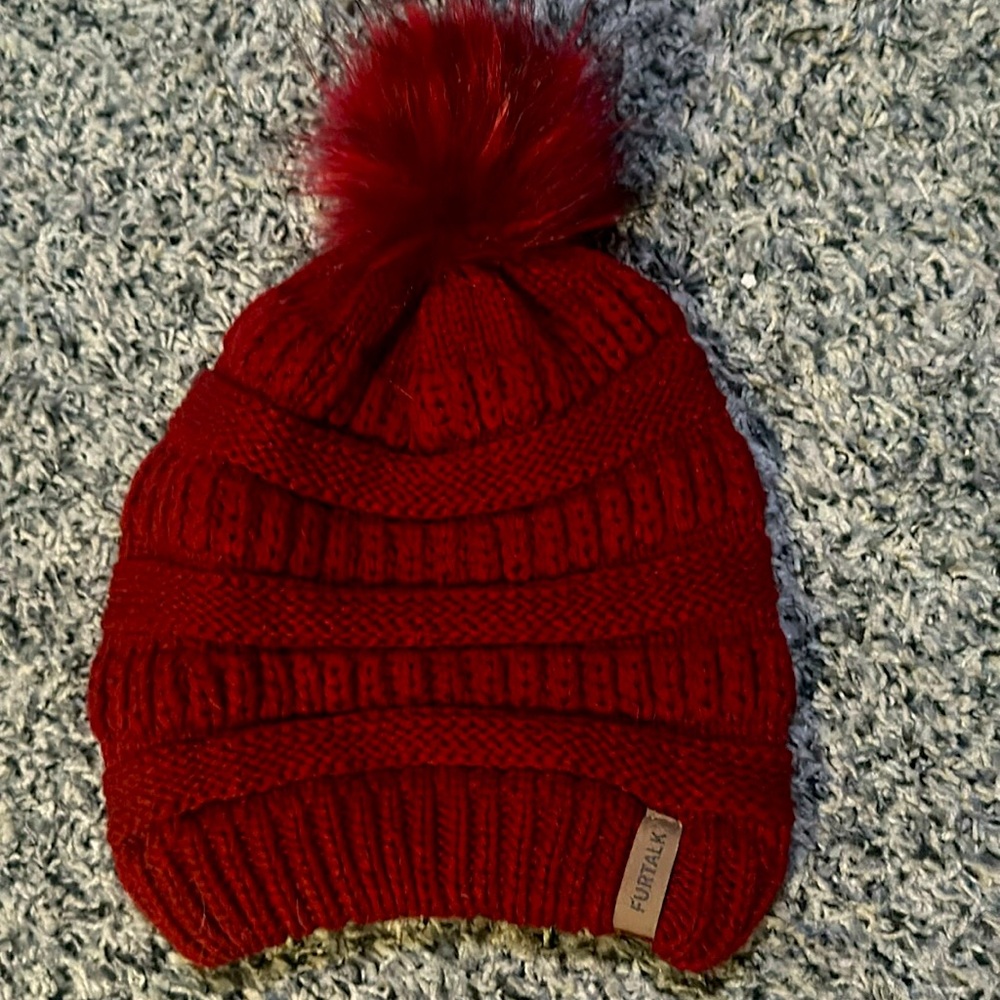 Woman’s Furtalk red knit ball beanie. 100% acrylic.